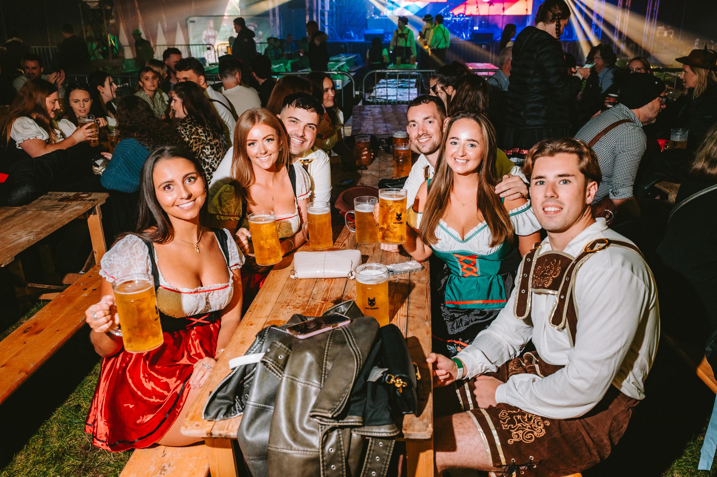 Guests enjoying beer together at an Oktoberfest table