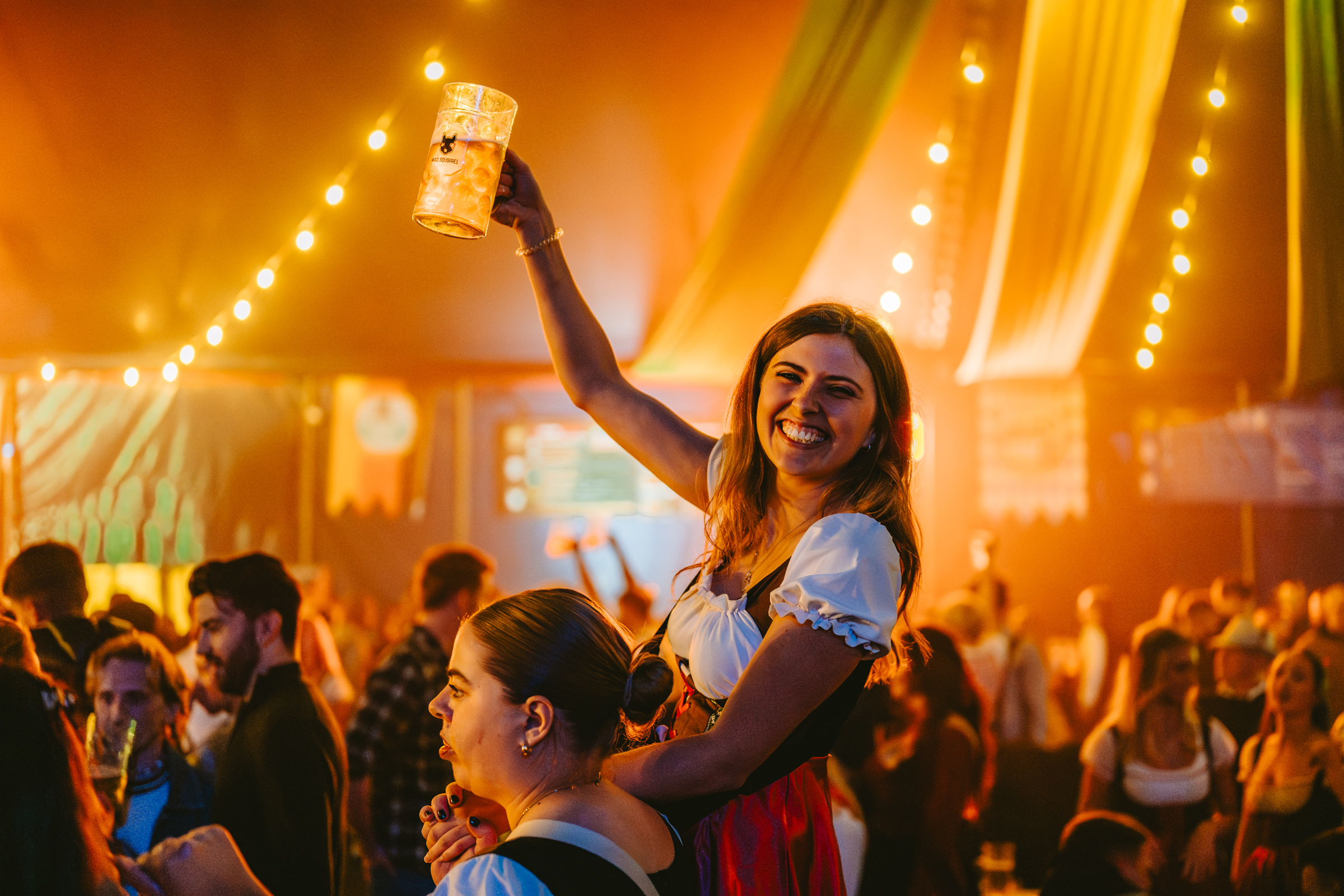Guest celebrating with a raised stein